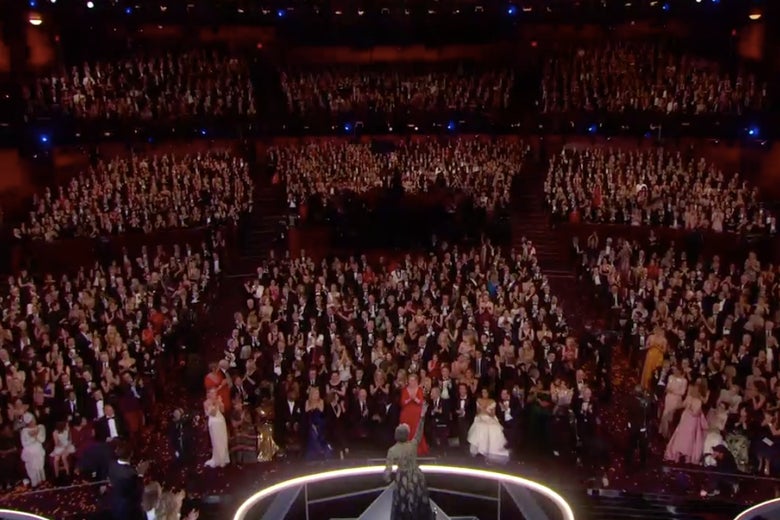 All the nominated women in the auditorium standing.
